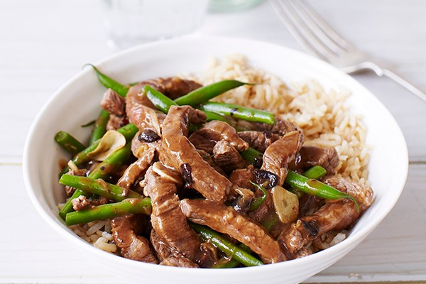 Beef and Black Bean Stir-Fry Recipe Big white bowl of Beef and Black Bean Stir-Fry with a silver fork