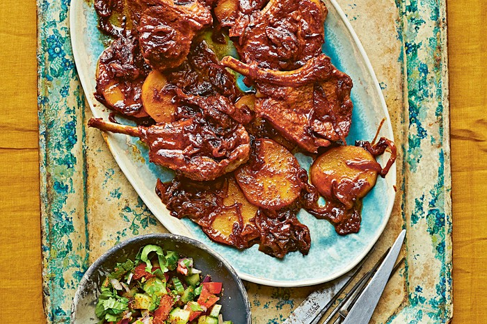 Lamb chop curry (Andhra chintakaya chaap) A blue rusted board topped with a platter of lamb chops covered in a ginger paste