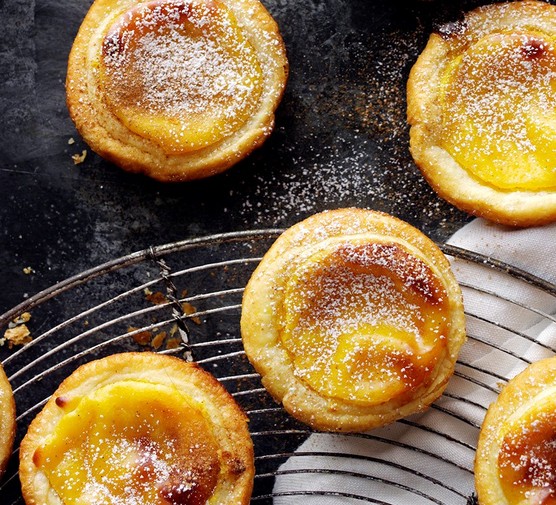 Portuguese Custard Tarts (Pastéis de Nata Recipe) Portuguese custard tarts on a cooling rach