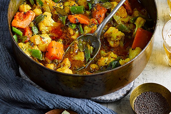 Sri Lankan Vegetarian Curry Recipe Pan of vegetarian curry with black pepper on the side