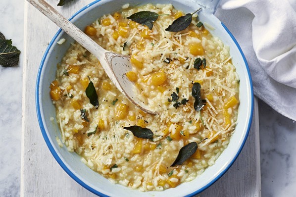 Butternut squash risotto A pot of butternut squash risotto with sage leaves