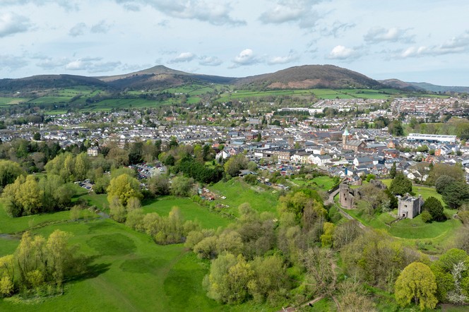Abergavenny and Sugar Loaf Mountain Aerial view of the historic town of Abergavenny and the landmark known as Sugar Loaf Mountain in Monmouthshire, South Wales, UK