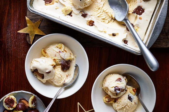 A rectangular tub of baileys ice cream next to two bowls