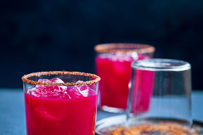 Beetroot mezcalita Two short glasses filled with beetroot mezcalita with salt on the rim
