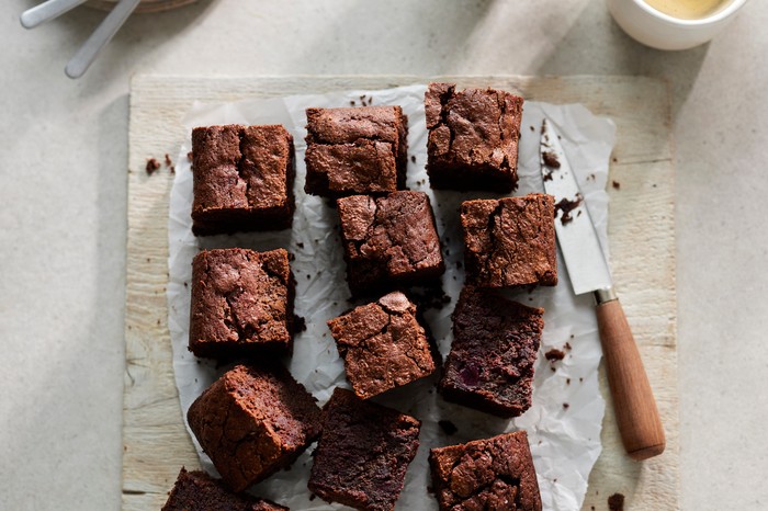 Beetroot brownies A slab of brownies cut into squares with a knife on the side