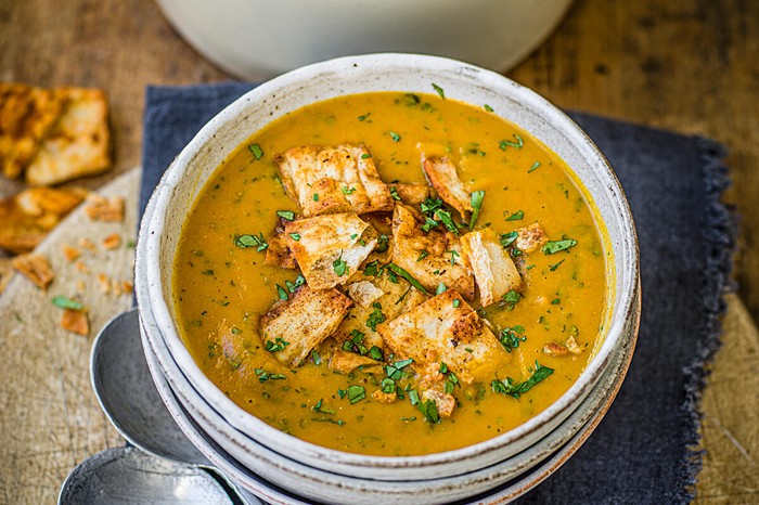 Carrot and coriander soup Carrot and coriander soup in a bowl with spicy flatbread croutons