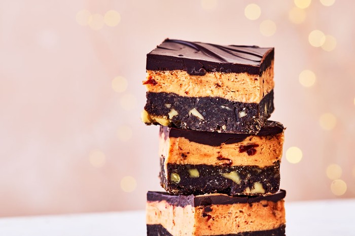 Cherry-nanaimo-bars-with-mahlab Chocolate and custard bars stacked in a pile