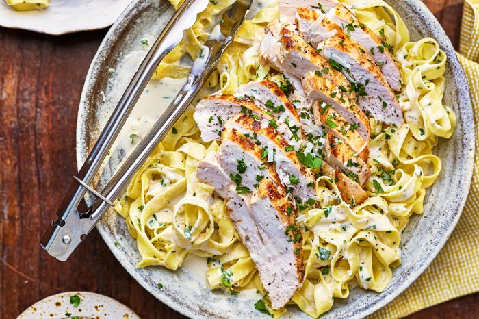 Chicken alfredo Sliced chicken on creamy tagliatelle