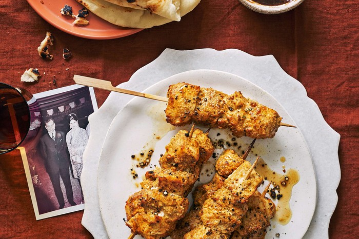 Chicken boti tikka Bundoo Khan-style Skewered marinaded chicken sticks on a white plate