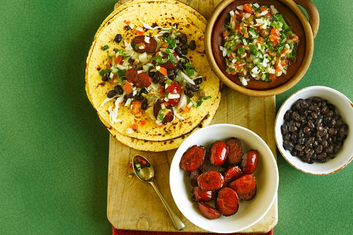 Chorizo tacos featuring pico de gallo, black beans and salad