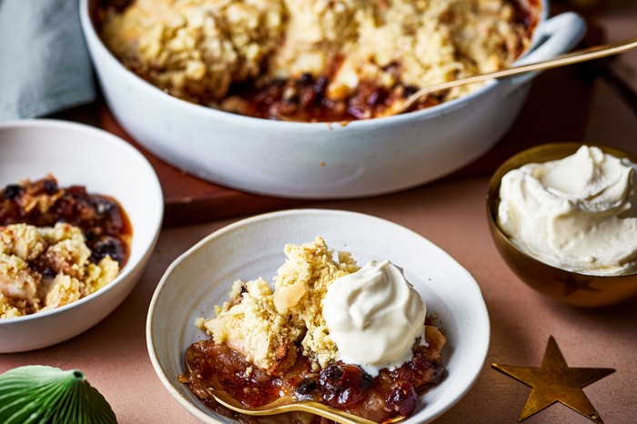 White bowls filled with Christmas crumble and cream