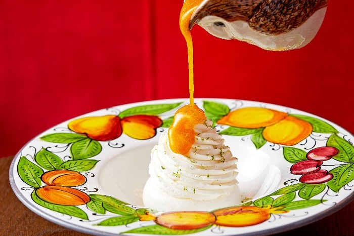 Ave Mario's christmas pavlovawith passion fruit coulis being pouts over the top