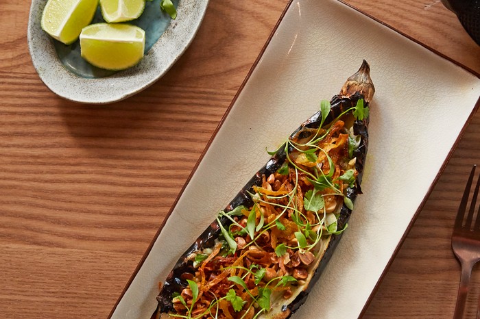 Burmese grilled aubergine Grilled aubergine with a small plate of lime wedges