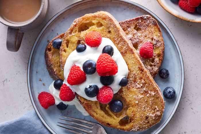 Classic french toast Stack of sourdough french toast with yogurt and berries on top
