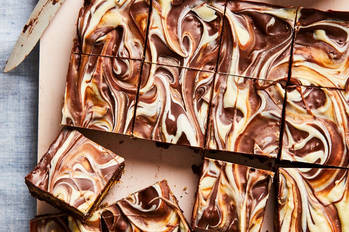 Chocolate tiffin recipe A tray of chocolate tiffin with swirled white chocolate and normal chocolate topping