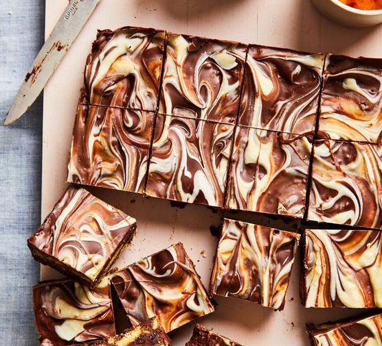 Chocolate tiffin recipe A tray of chocolate tiffin with swirled white chocolate and normal chocolate topping
