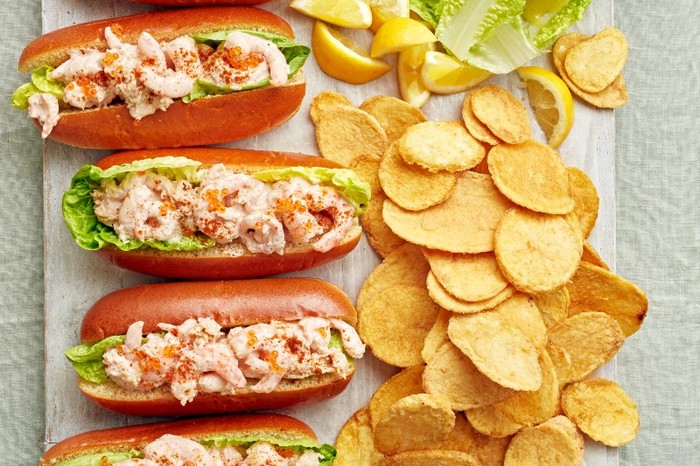 Crab and prawn cocktail rolls a tray of finger rolls filled with prawn cocktail next to a scattering of crisps