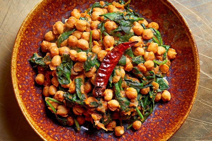 Saag channa masala (spinach with chickpeas) A chickpea curry with spinach and a red chilli on top