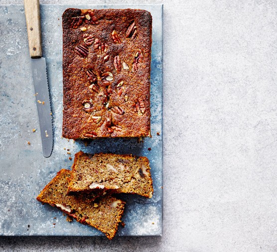 Loaf Cake Recipes Date and pecan loaf cake on a board with two slices cut