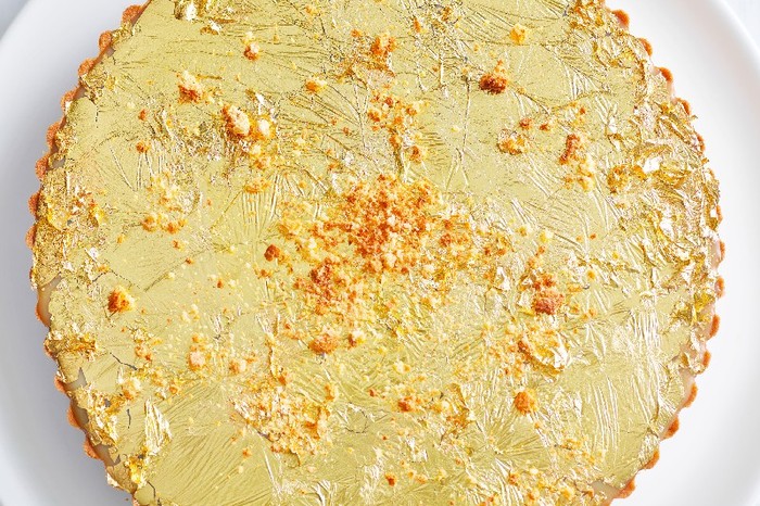Double chocolate and passion fruit tart topped with edible gold