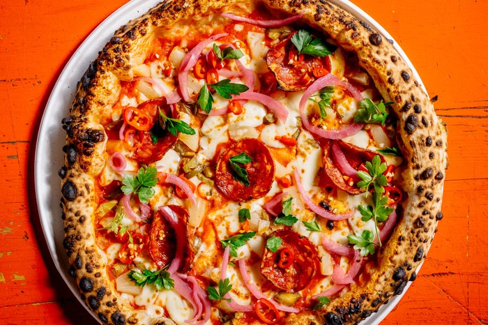 Ace Pizza A New York Neapolitan style pizza with pepperoni, pickled onions, parsley cheese and chilli