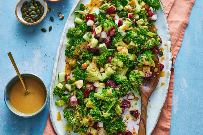 Feel-good winter salad Platter of winter salad next to a ramekin of dressing