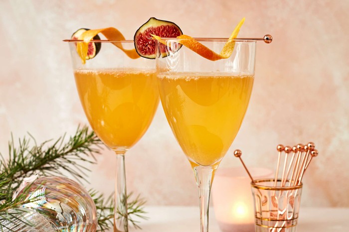 Fig and grapefruit twinkle Two cocktails set against a festive background