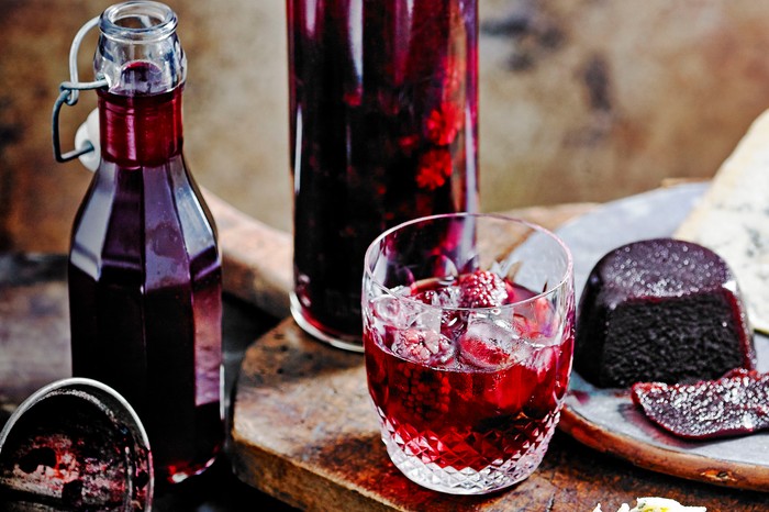 Blackberry Whisky Recipe A glass bottle filled with blackberry whisky next to a full glass