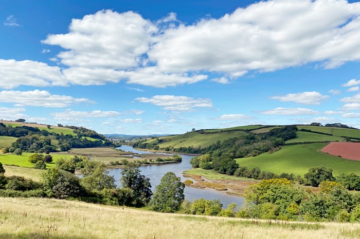 Country River A wide river runs through country fields in the summer sun. Taken of the River Dart from near Totnes, Devon.