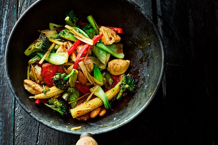 Ginger Chicken Stir-fry Ginger chicken and vegetable stir-fry in a wok