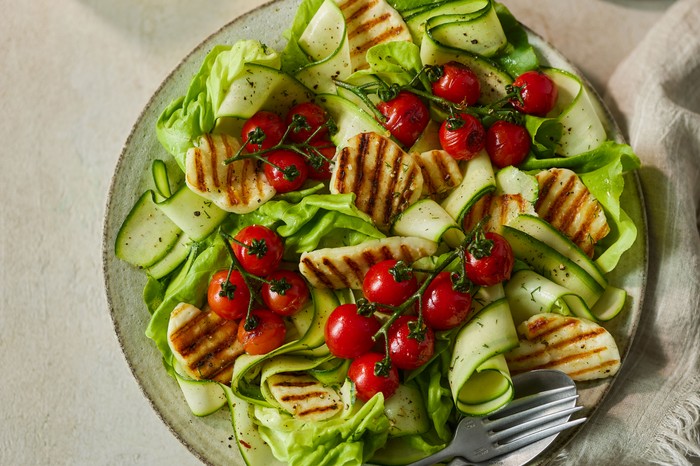 Grilled halloumi salad A salad of grilled halloumi, courgette ribbons and cherry tomatoes
