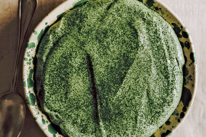 Matcha tiramisu A bright green tiramisu on a circular serving plate