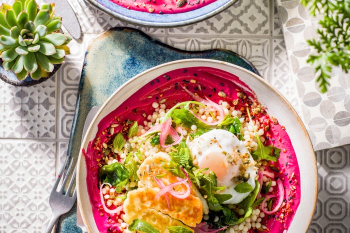 Halloumi breakfast bowls Halloumi, eggi and salad bowl on a bed of pureed beetroot borani yogurt