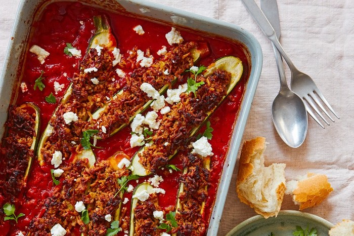 Harissa lamb-stuffed courgettes An oven dish of harissa lamb-stuffed courgettes in a red sauce