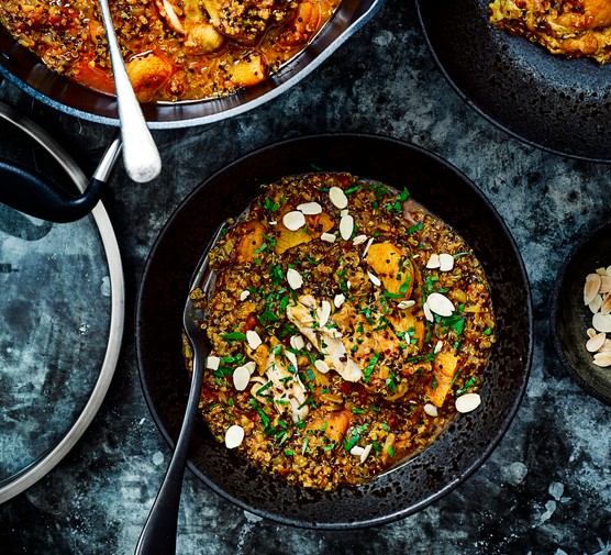 One-pot Chicken and Quinoa Tagine Chicken and Quinoa Tagine in a Black Bowl topped with Sliced Almonds