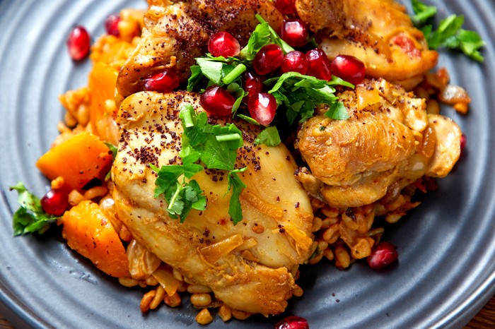 Imad's Syrian Chicken A chicken thigh dish topped with pomegranates