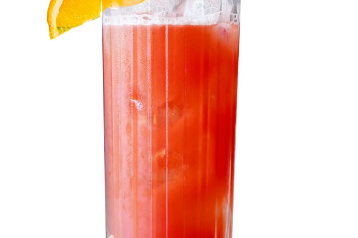 IPA-and-campari-shandy High glass filled with red liquid and wedge of orange on the rim