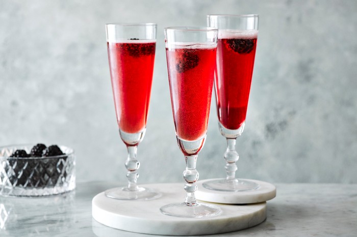 Kir royale recipe Three kir royale cocktails with blackberries in the background