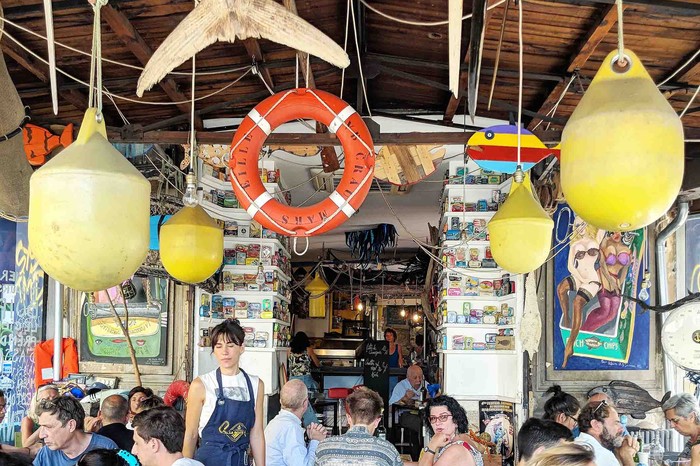 La Boite a Sardine Marseille A busy restaurant with buoys hanging from ceiling