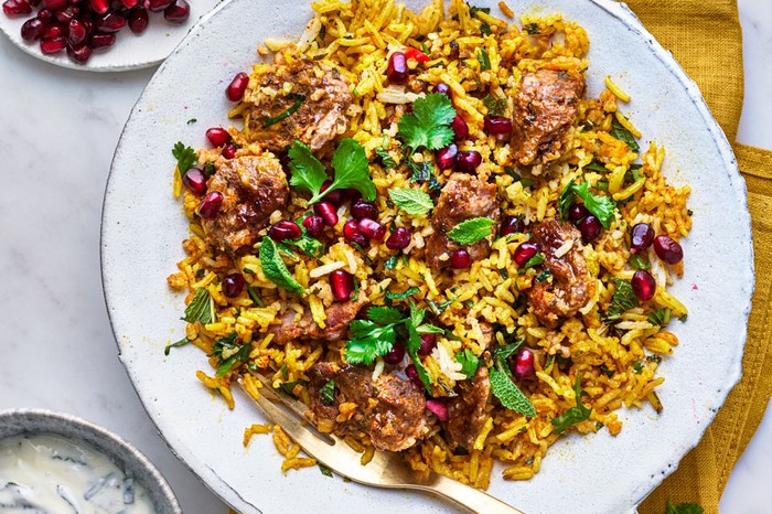 Lamb biryani Plate of lamb biryani topped with pomegranate seeds and coriander leaves