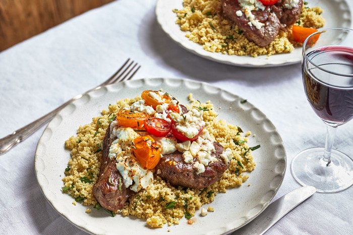 Lamb Steaks Recipe Lamb Steaks on a plate of couscous, plus another plate in the background
