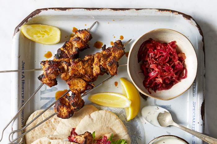 Lamb Shish Kebabs Recipe Lamb shish kebabs with pitta pockets and caramelised onions in a bowl