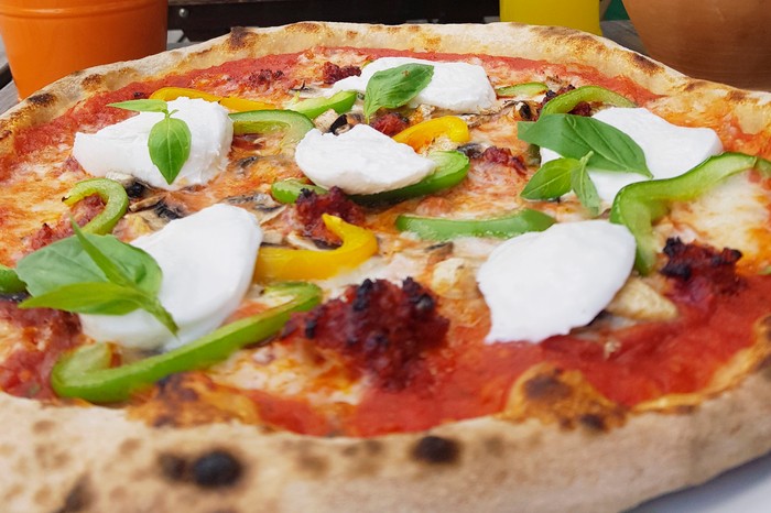 Lamezia Pizza A pizza topped with torn white cheese and green peppers