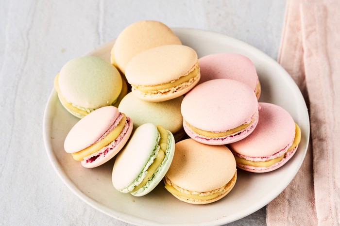 Macarons A plate of pastel-coloured macarons on a white surface with a pink linen napkin