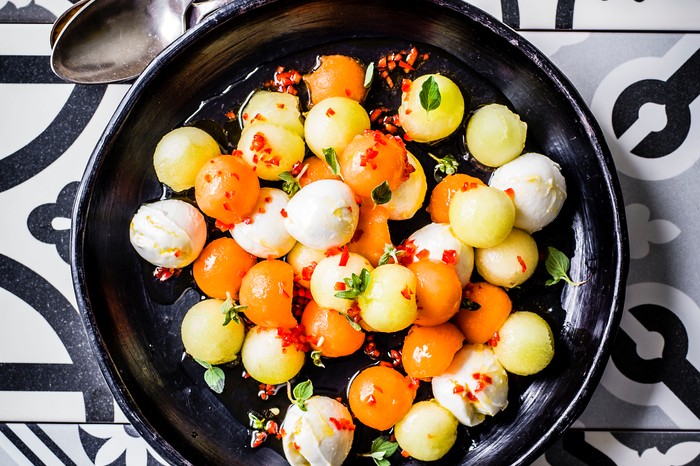 Melon and Mozzarella Salad Recipe Colourful melon and mozzarella balls in a black salad bowl