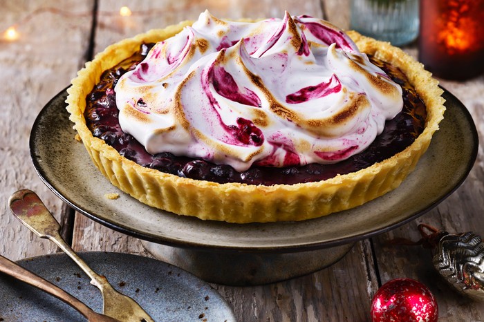 Vegan blueberry meringue pie A beautiful blueberry tart with a crown of scorched meringue on top of it