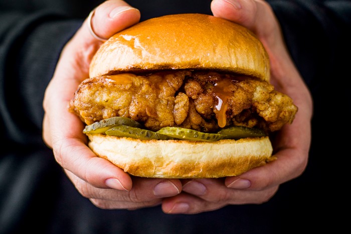 Fried chicken sandwich Fried chicken sandwich being held in hands