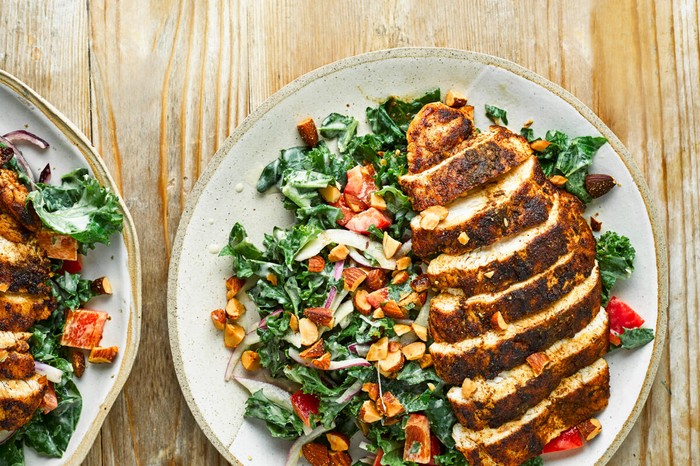 Cumin-crusted chicken with kale salad Cumin-Crusted Chicken with Kale Salad on two Plates