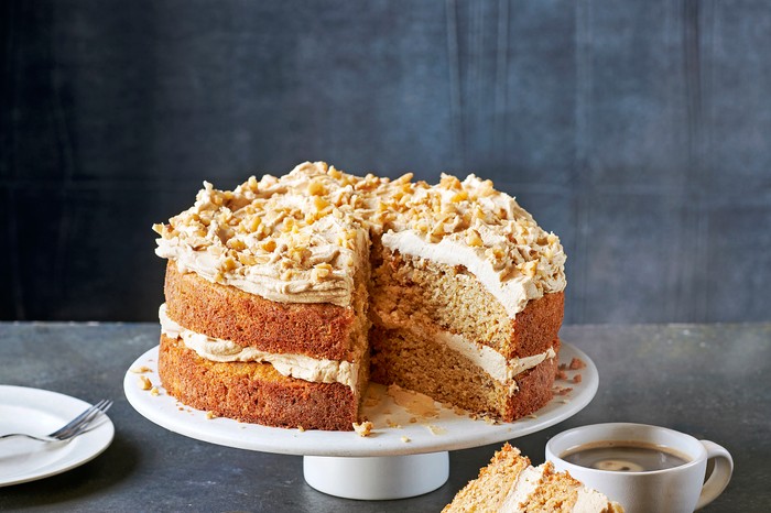 Golden syrup cake A white cake stand topped with a coffee and walnut sponge cake with a cream coffee icing