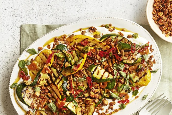 BBQ courgette with labneh and savoury granola A platter of charred courgettes on a linen napkin
